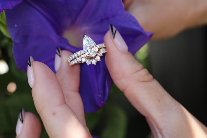 yellow gold pear cut engagement ring and curved wedding band